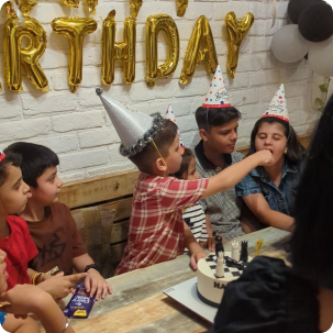 Kids birthday cake cutting celebration at Pepper Pot Café
